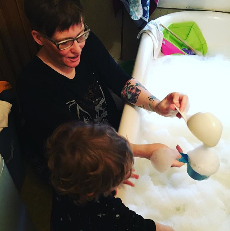 Mom and child fill bath tub