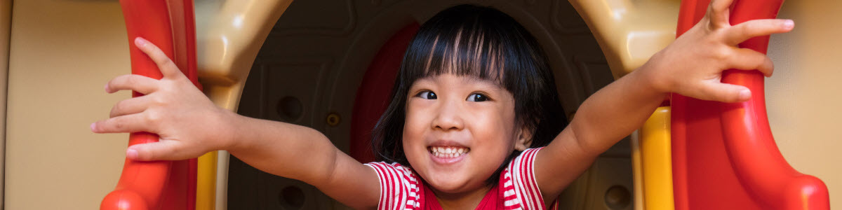 Little girl welcoming friends into her playhouse