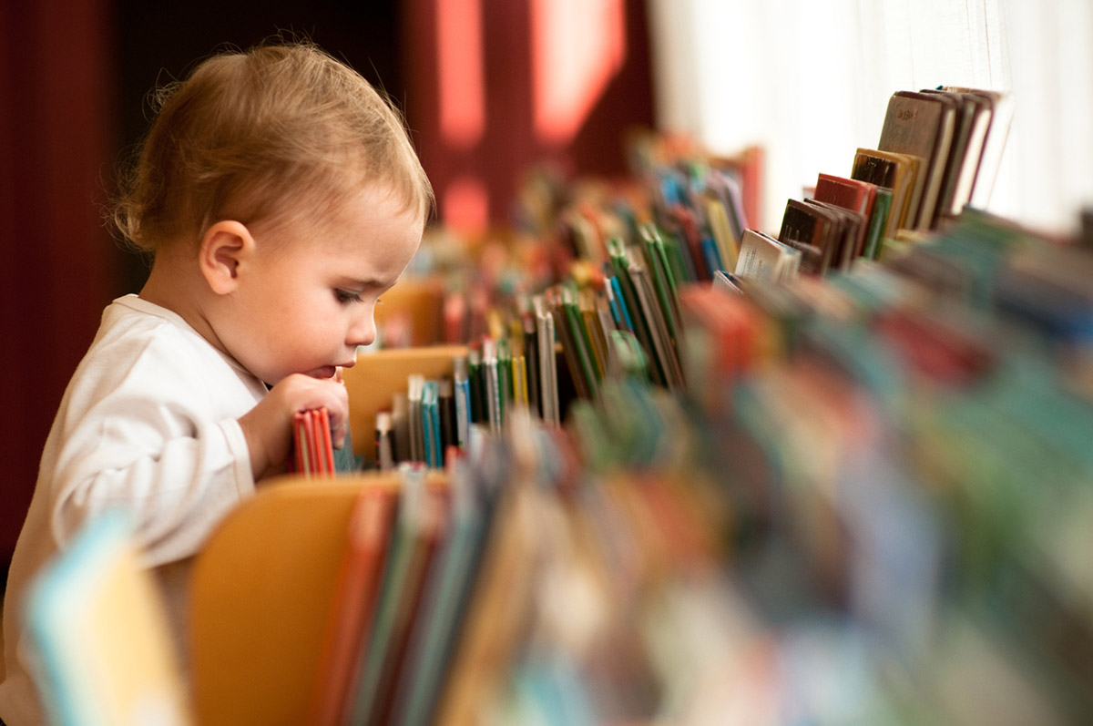 Toddler Looking Through Books