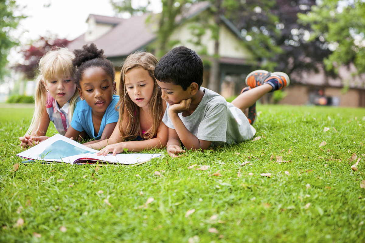 Kids Reading on Grass